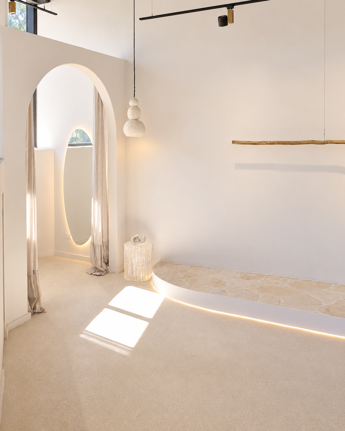 Natural light across the arched doorway and curved stone bench at Artemuse Studio