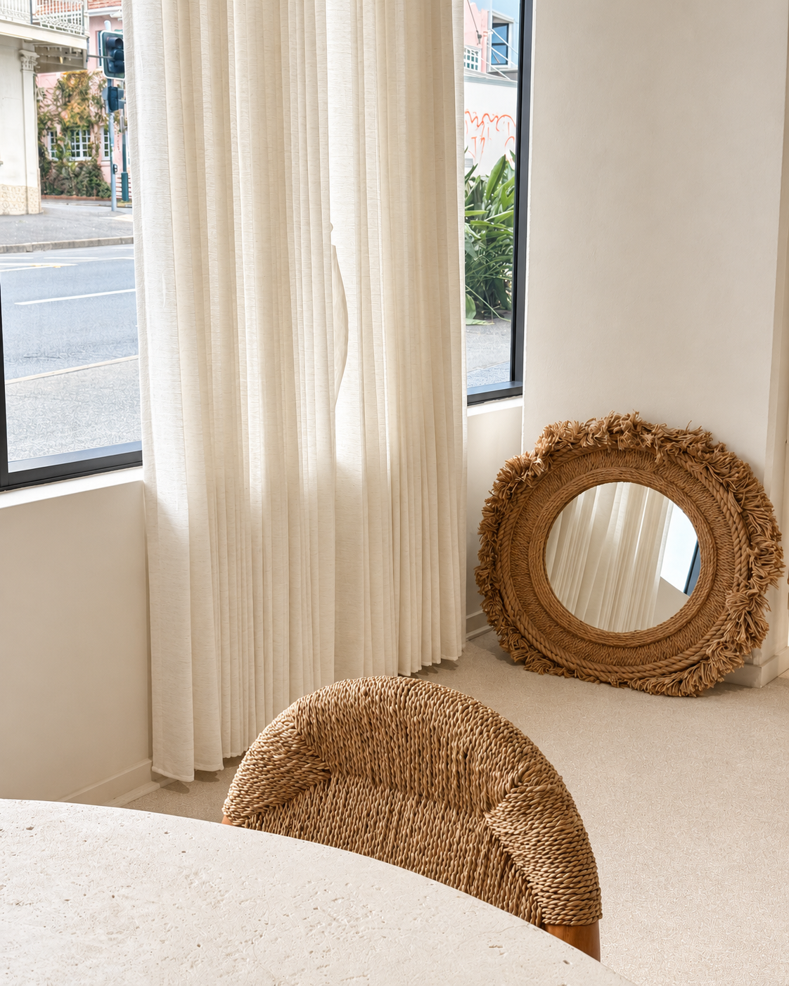 Sheer curtains, woven chair and round mirror in natural light at Artemuse Studio